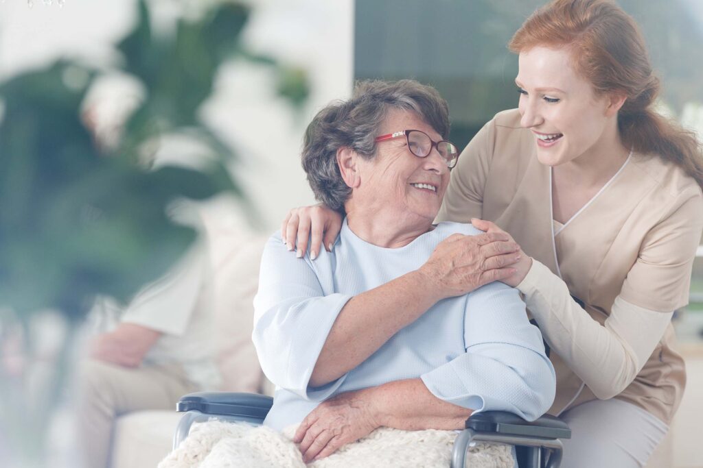 Happy patient is holding caregiver for a hand while spending time together